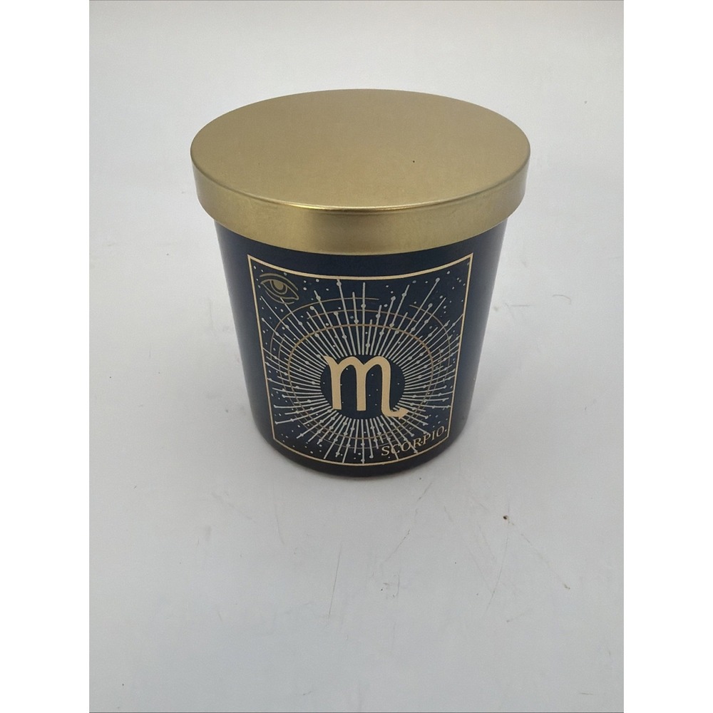 gold Scorpio zodiac symbol and lid from the Ashland Zodiac Scented Candle